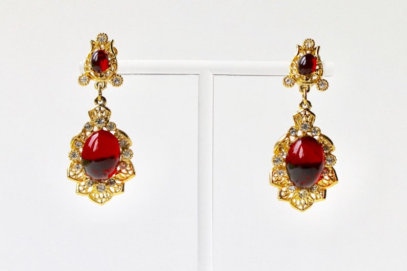 Rhinestones Indian inspired earrings Faux ruby cabochon chandelier earrings. Vintage Sphinx gold and red cabochon dangle clip on earrings