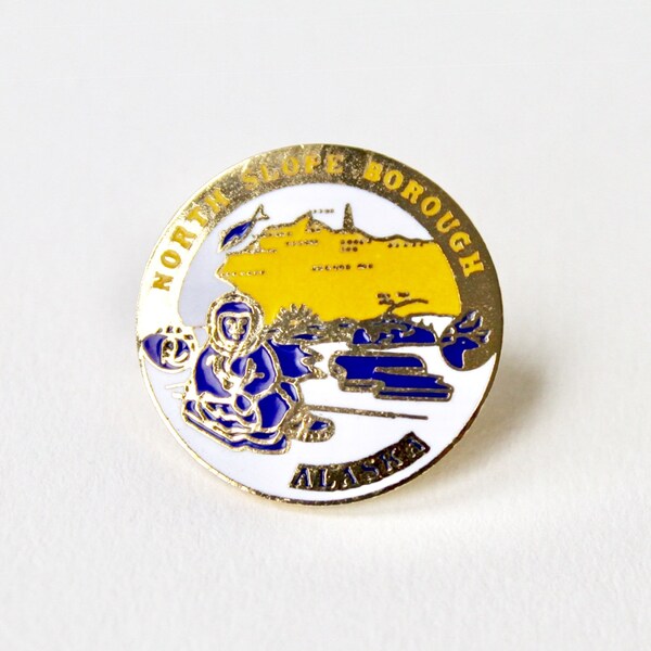 Vintage enamel Alaska pin. North Slope Borough Alaska logo pin. North American continent pin. Ice seal pin. Enamel round Alaska brooch pin.