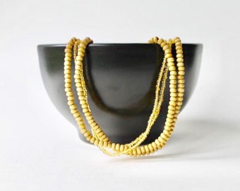 Vintage wood bead multi strand statement necklace. Natural style yellow seed beads boho necklace. 1990's wood bead multi strand bead chain.