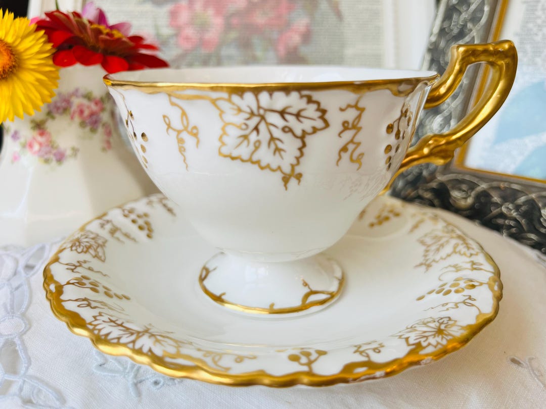 Royal Crown Derby Embossed Gold Teacup and Saucer With Grape Vines