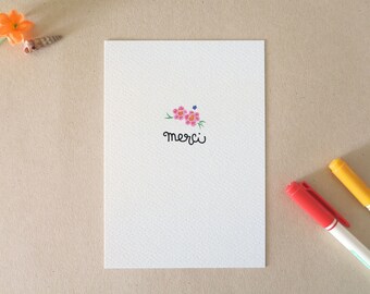 Greeting card printed with pink flowers and THANK YOU message in a personal lettering