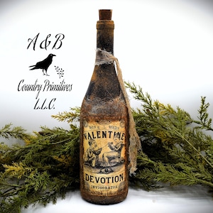 May include: A rustic brown glass bottle with a burlap tied around the neck. The bottle has a vintage label that reads "His & Hers Valentine Devotion Invigorator". The label features a black and white illustration of a couple sitting at a table.
