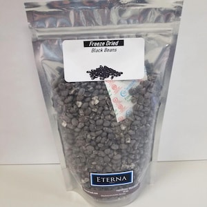 May include: A clear plastic bag filled with freeze-dried black beans. The bag has a label that reads "Freeze Dried Black Beans".