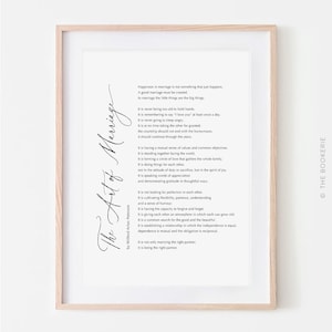 May include: A framed print with the title "The Art of Marriage" in elegant script. The print features a poem about marriage by Wilferd Arlan Peterson, set against a white background within a light wood frame.