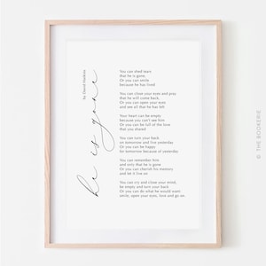 May include: A framed print with a poem by David Harkins in black script. The poem's title, "Rest in Love", is written in cursive on the left side. The text is on a white background, and the frame is light brown.