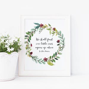 May include: A white framed print with a watercolor wreath of green leaves and burgundy flowers. The quote "We shall find our little ones again up above - St. Zita Martin" is printed in black inside the wreath.