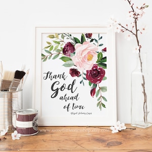 May include: Printable art print with a floral design in shades of pink and burgundy. The text reads "Thank God ahead of time - Blessed Solomon Casey".