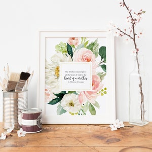 May include: A printable art print featuring a watercolour floral design in shades of pink and white. The print includes a quote by St. Th&eacute;r&egrave;se of Lisieux: "The loveliest masterpiece of the heart of God is the heart of a mother."