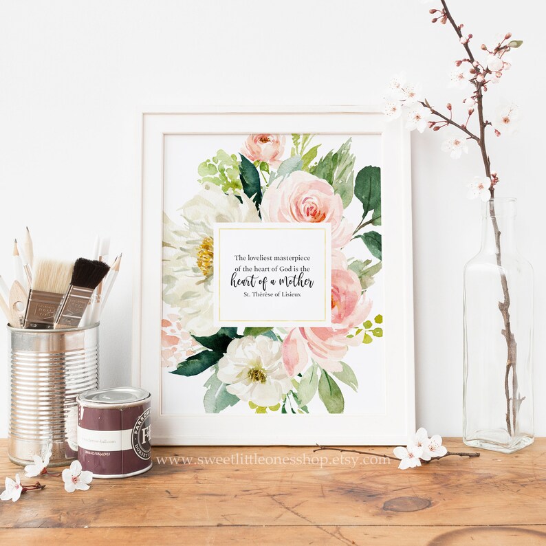 May include: A printable art print featuring a watercolour floral design in shades of pink and white. The print includes a quote by St. Th&eacute;r&egrave;se of Lisieux: "The loveliest masterpiece of the heart of God is the heart of a mother."