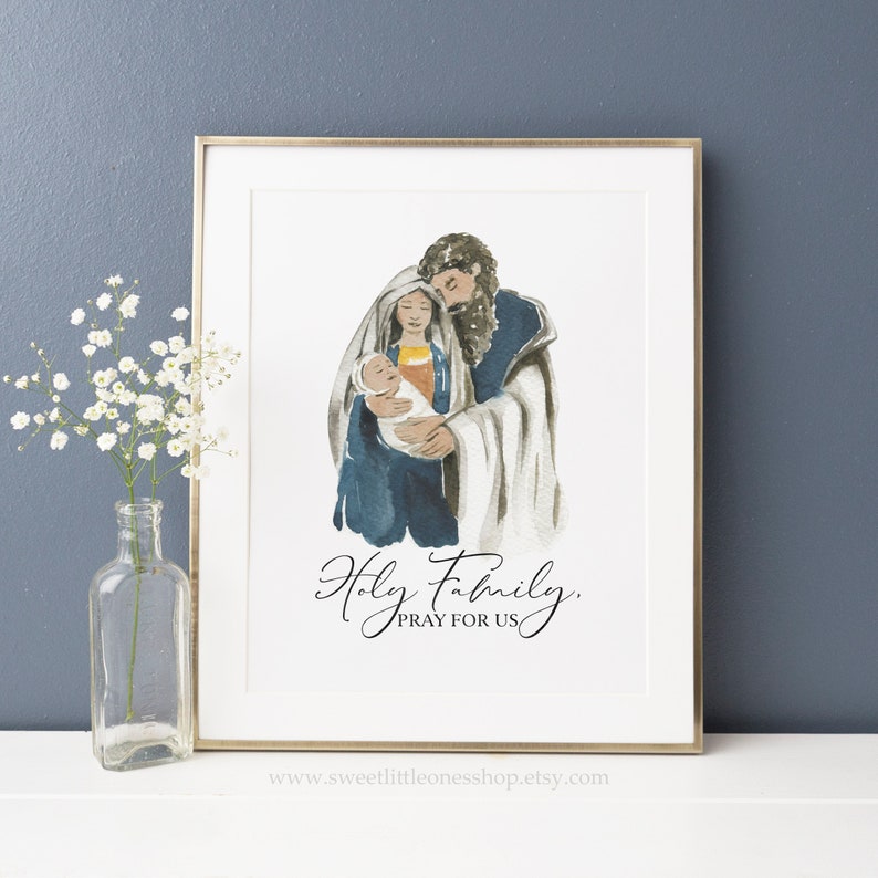May include: A watercolor painting of the Holy Family, Mary, Joseph, and baby Jesus. The painting is in shades of blue, brown, and white. The text "Holy Family, Pray for Us" is written below the image.