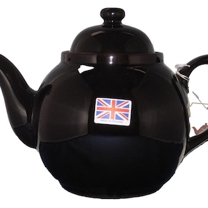 May include: A glossy black teapot with a rounded body, spout, and handle. The lid has a small knob. A sticker with the Union Jack flag is on the front. The teapot is a classic design, suitable for serving tea.