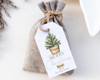 May include: A small burlap gift bag tied with twine, featuring a white tag with a watercolor illustration of a potted Christmas tree. The tag reads "Merry Christmas" with "The Smith Family" below.