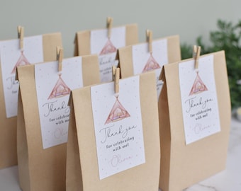 May include: Brown paper bags with thank you tags attached with clothes pegs. The tags feature a watercolour illustration of a pink and brown tent with the text "Thank you for celebrating with me Olivia."