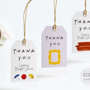 May include: Three purple and white thank you tags with the text "THANK YOU" in black with colorful dots. Each tag has a different image: a yellow frame, a brown couch, and three colorful umbrellas. The text "Lauren's Bridal Shower" is on two of the tags.