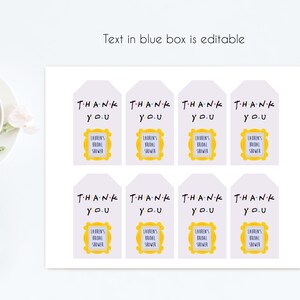 May include: Eight white favor tags with the text "THANK YOU" in black and a yellow frame with the text "LAUREN'S BRIDAL SHOWER" in purple.