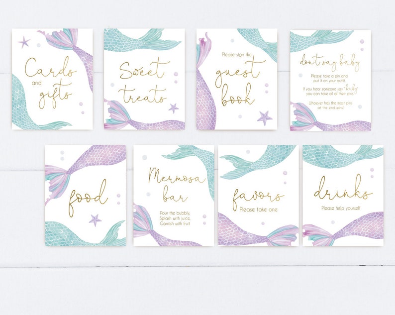 May include: Set of ten printable mermaid-themed signs for a baby shower. The signs feature a mermaid tail with purple and blue scales and gold lettering. The signs include: Cards and Gifts, Sweet Treats, Guest Book, Don't Say Baby, Food, Mimosa Bar, Favors, Drinks.
