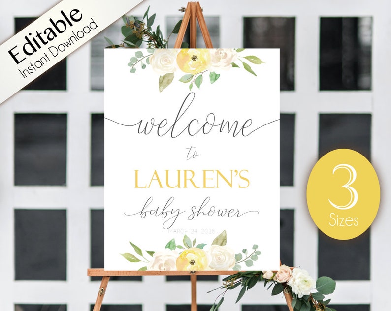 May include: A white welcome sign with yellow and white flowers and greenery. The sign says "Welcome to Lauren's Baby Shower".