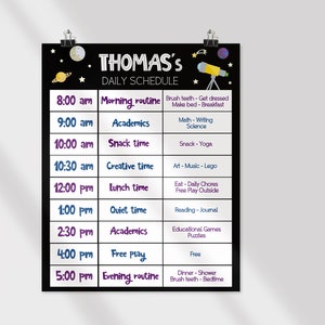 May include: A black and white daily schedule chart for a child named Thomas. The chart lists activities for each hour of the day, including morning routine, academics, snack time, creative time, lunch time, quiet time, free play, and evening routine. The chart is decorated with stars, a moon, and a telescope.