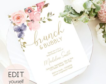 May include: A white invitation card with gold lettering for a bridal shower. The invitation features a watercolor floral design with pink, purple, and green flowers. The text reads "brunch & bubbly" and includes the bride's name, date, time, and location. RSVP information is also included.