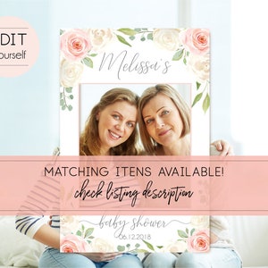 May include: A pink and white floral photo booth frame with the text "Melissa's Baby Shower 06.12.2018" and a photo of two women.