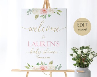 May include: A white welcome sign with pink and white flowers and greenery. The sign says "welcome to LAUREN'S baby shower MARCH 24, 2018".