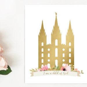 May include: A gold silhouette of a temple with pink and green floral accents and a banner that reads "I am a child of God".