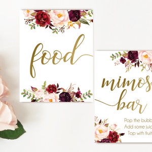 K&ouml;nnte beinhalten: Zwei druckbare Schilder mit burgunderroten und blushfarbenen Blumendesigns. Das erste Schild sagt "food" in goldener Schrift. Das zweite Schild sagt "mimosa bar" in goldener Schrift und enth&auml;lt die Anweisungen: "Pop the bubbly, Add some juice, Top with fruit."