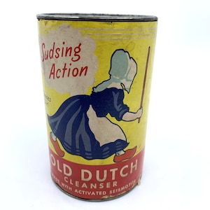 May include: Vintage Old Dutch Cleanser can with a yellow background and a cartoon image of a Dutch woman. The can features the words "Sudsing Action" and "Old Dutch Cleanser" in red and white text.