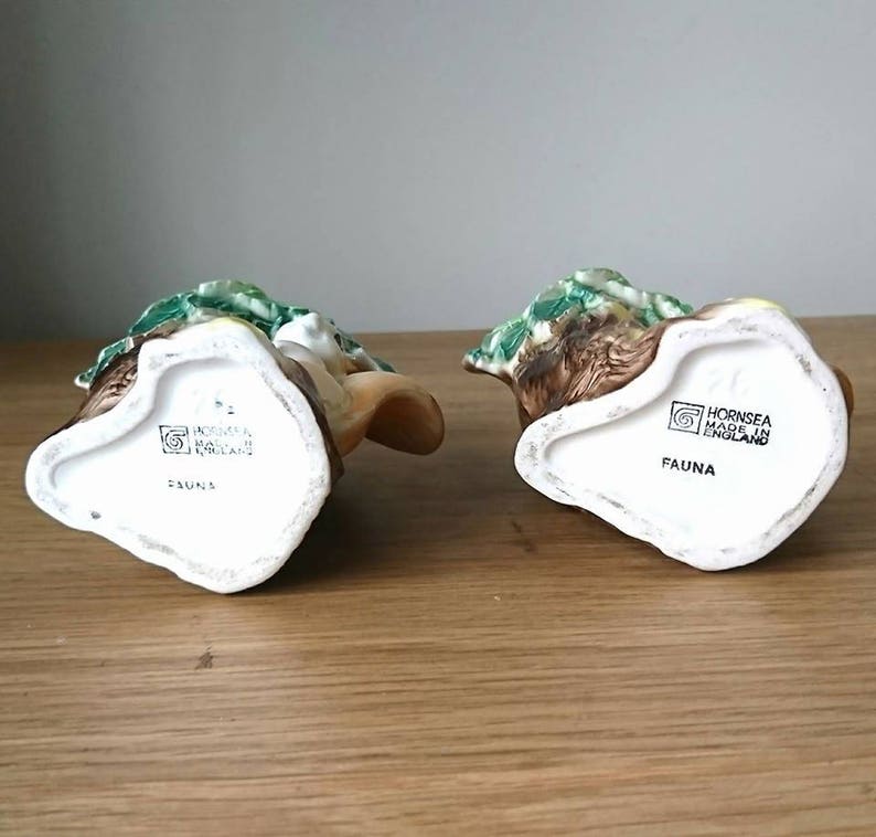 May include: Two ceramic figurines of woodland animals, a rabbit and a deer, with green and brown painted details. The bottom of each figurine has the text "Hornsea Made in England" and "Fauna".