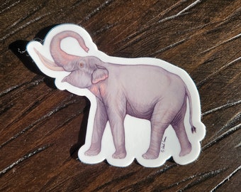 May include: A sticker of a pink elephant with its trunk raised in the air. The elephant is standing on a wooden surface.