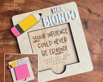 May include: A wooden frame with a pencil and the text "Mrs. Biondo Your Influence Could Never Be Erased! Thank You For Everything You Do". A pink sticky note is in the frame.