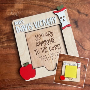 May include: Wooden frame with a cutout for a photo or note. The frame is decorated with red apples and the text "MRS DAVIS-VICKERY YOU ARE AWESOME, TO THE CORE! THANK YOU FOR EVERYTHING YOU DO".