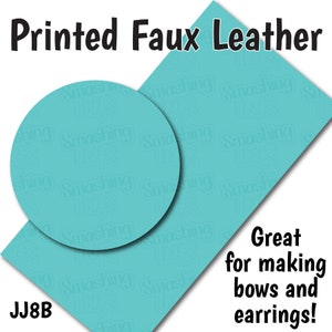 May include: Printed faux leather sheet in a turquoise blue color with a repeating pattern of the words "Smashing Tutus". The sheet is cut into a rectangle shape with a circle cut out of the center. The text "JJ8B" is in the lower left corner. The text "Great for making bows and earrings!" is in the lower right corner.