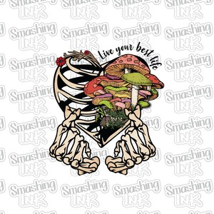 May include: A graphic illustration featuring a heart-shaped rib cage with colorful mushrooms and the text "Live your best life." The design includes skeleton hands and a floral accent, set against a white background.