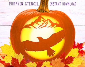 May include: An orange pumpkin stencil with a mountain and eagle design. The pumpkin is surrounded by colorful autumn leaves. Text at the top reads "PUMPKIN STENCIL" and "INSTANT DOWNLOAD".