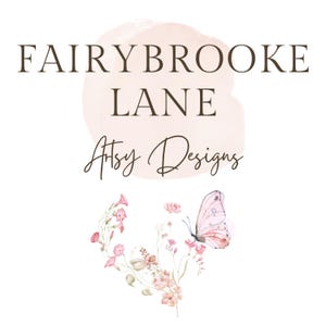 May include: Logo for Fairybrooke Lane Artsy Designs. The logo features text in a serif font with the words "Fairybrooke Lane" above "Artsy Designs" in a script font. A watercolor-style pink floral and butterfly illustration is below the text.