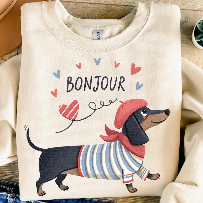 Dachshund PNG Bonjour Paris Png.  Adorable Paris dachshund dog wearing a French beret and a Breton striped sweater with the word bonjour above it with cute hearts. Instant down.