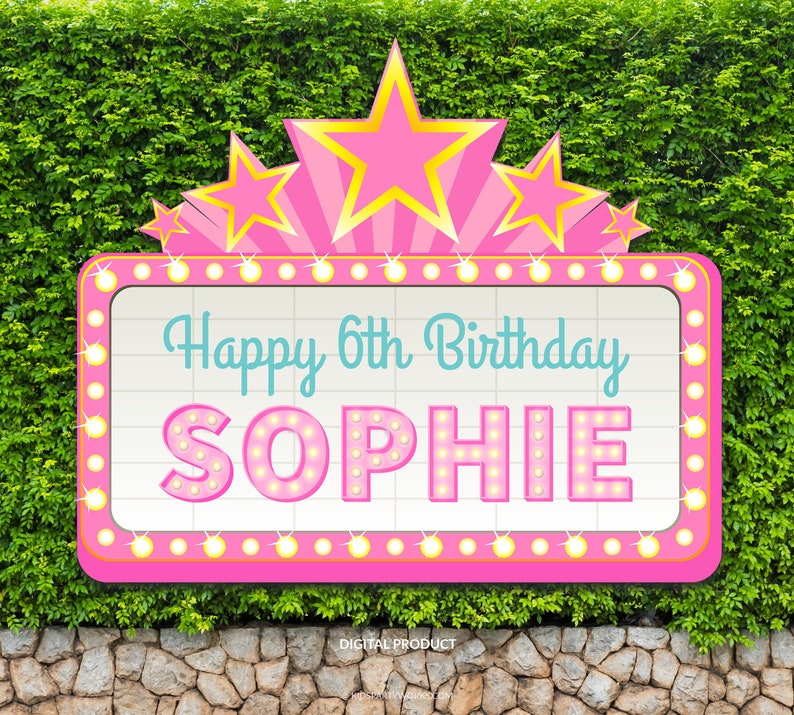 May include: Pink and yellow star-shaped marquee sign with the text "Happy 6th Birthday Sophie" in a white box with a grid pattern.