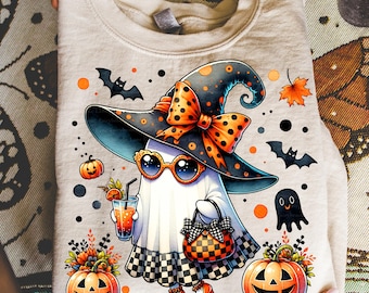 May include: A beige sweatshirt featuring a Halloween-themed graphic. The design includes a ghost wearing a witch hat, sunglasses, and holding a purse and a drink. Pumpkins, bats, and fall leaves complete the festive illustration.