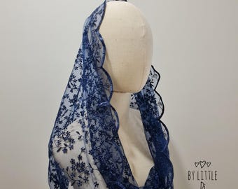 May include: A dark navy blue lace chapel veil featuring an intricate floral pattern and a scalloped edge. The sheer fabric drapes over a mannequin head. The text "BY LITTLE Di" with three small hearts is printed in the lower right corner.