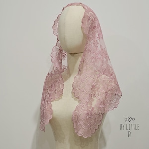 May include: A dusty rose lace chapel veil featuring a scalloped edge with intricate floral embroidery patterns. The veil is draped over a mannequin head and shoulders. The text BY LITTLE Di with three small hearts is printed in the bottom right corner.