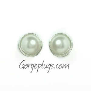 May include: A pair of white pearl earrings with silver settings.