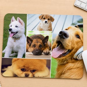 May include: A rectangular mouse pad featuring a photo collage of five dogs. The images include a white puppy, a small brown puppy, a German Shepherd, a fluffy orange dog, and a golden dog wearing white headphones with its tongue hanging out.
