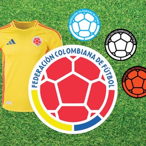 May include: A yellow soccer jersey with the Adidas logo and the Colombian national team crest. The crest features a red soccer ball with white panels and the text "Federación Colombiana de Fútbol".