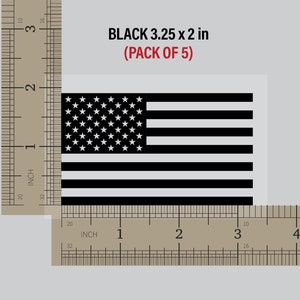 May include: A pack of five black American flag decals, each measuring 3.25 inches by 2 inches. The decals are shown against a ruler for size reference.