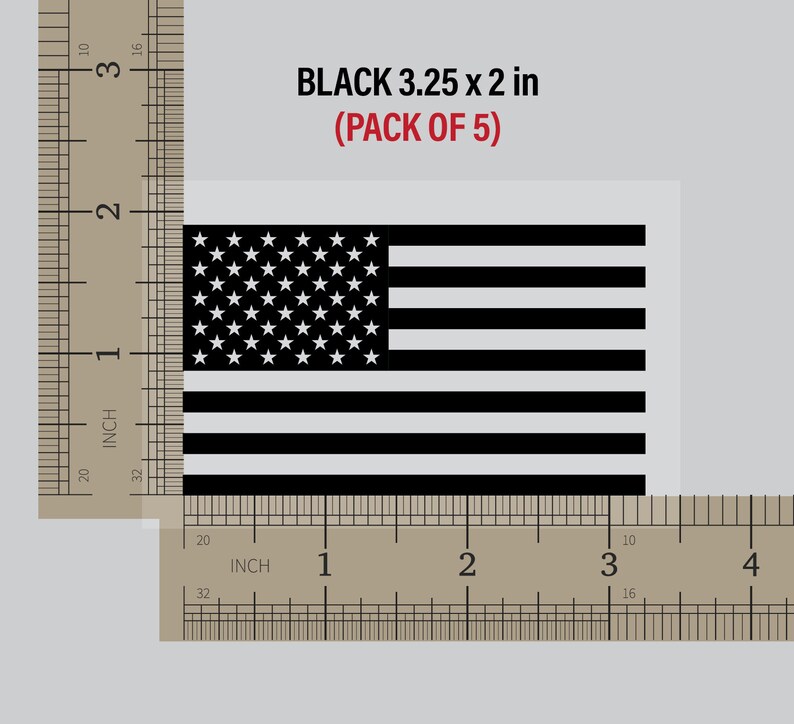 May include: A pack of five black American flag decals, each measuring 3.25 inches by 2 inches. The decals are shown against a ruler for size reference.