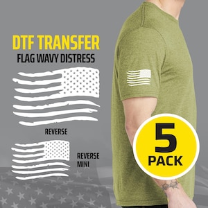 May include: A heather olive green t-shirt featuring a white distressed American flag graphic on the sleeve. The image displays text reading DTF TRANSFER FLAG WAVY DISTRESS, showing a large and a mini reverse flag design, and a 5 PACK yellow circle.