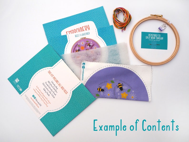 Contents of an embroidery kit including colourful threads, an embroidery hoop, a needle, a pre-printed fabric piece with a bee and flower design, felt padding, and an instruction booklet. Text at the bottom reads Example of Contents.