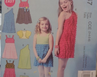 Patrón de costura McCall's M6547 para niña: vestido, top, chaqueta corta, pantalones cortos y leggings, tallas 3-6.