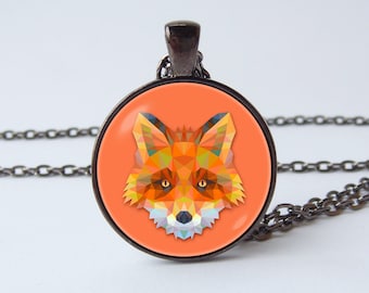 May include: A necklace with a round pendant featuring a geometric fox design in shades of orange, yellow, and blue on a coral background. The pendant is attached to a black chain.
